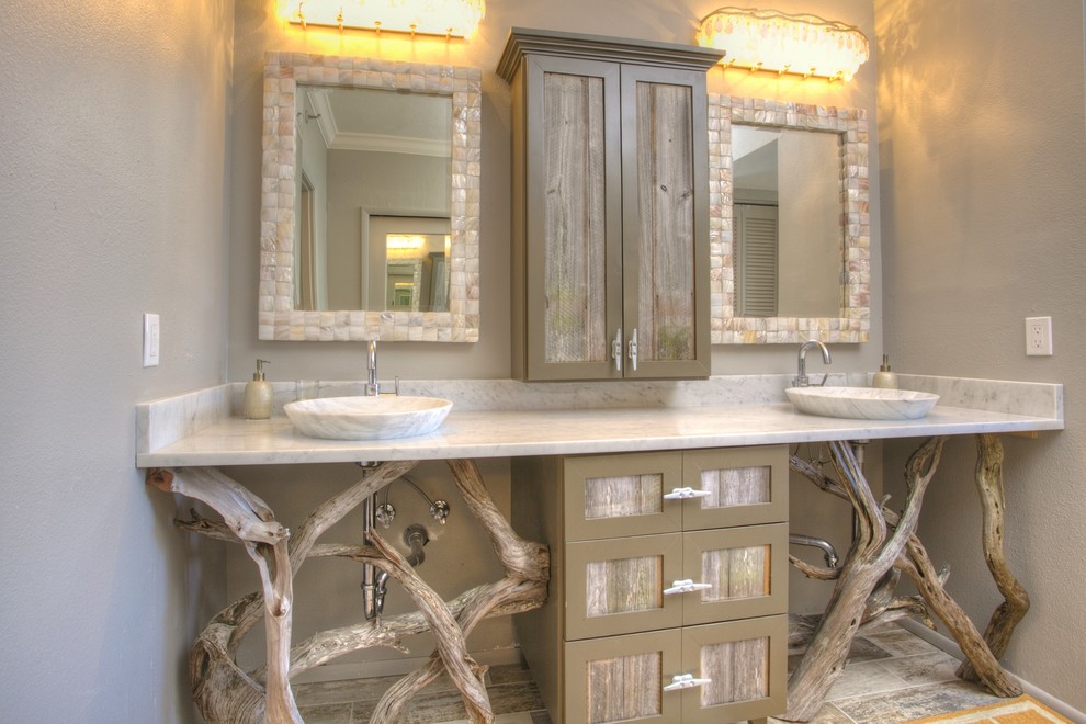 Tropical bathroom in Tampa with a vessel sink, furniture-like cabinets, beige cabinets and marble benchtops.