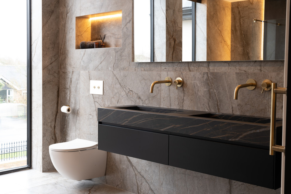 Design ideas for a contemporary family bathroom in Other with flat-panel cabinets, black cabinets, a wall mounted toilet, brown tiles, porcelain tiles, brown walls, porcelain flooring, granite worktops, brown floors, brown worktops, double sinks, a floating vanity unit, an integrated sink and a wall niche.