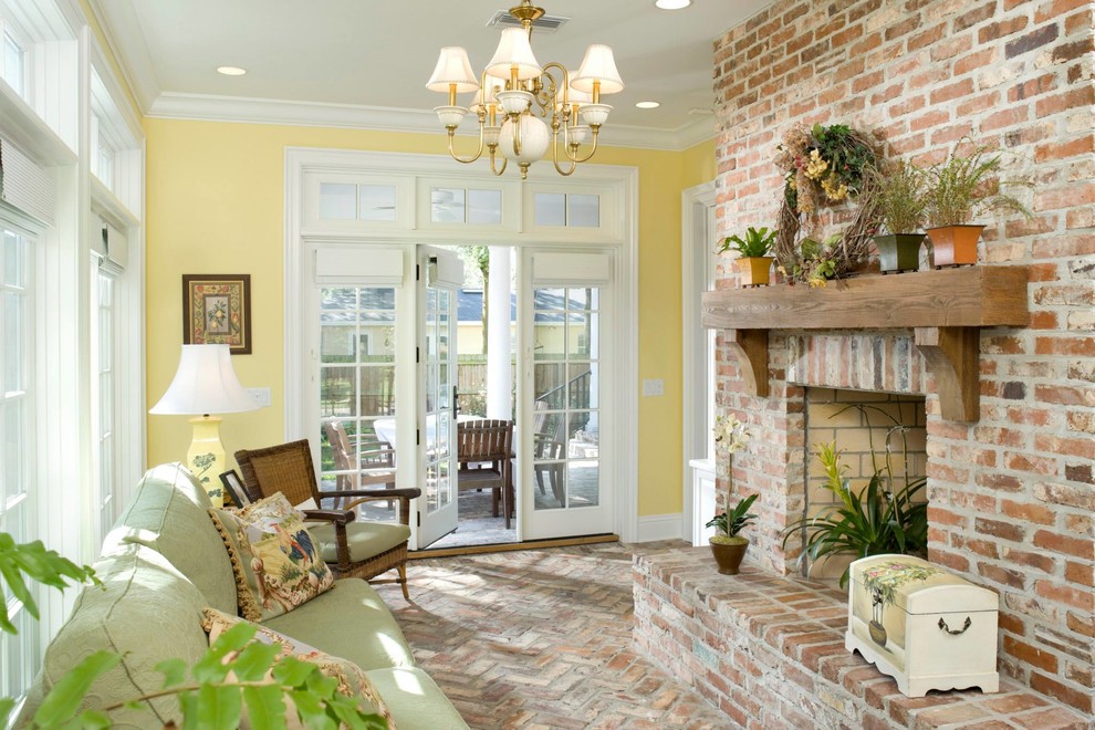 Inspiration for a traditional sunroom in Tampa with brick floors, a standard ceiling and a brick fireplace surround.