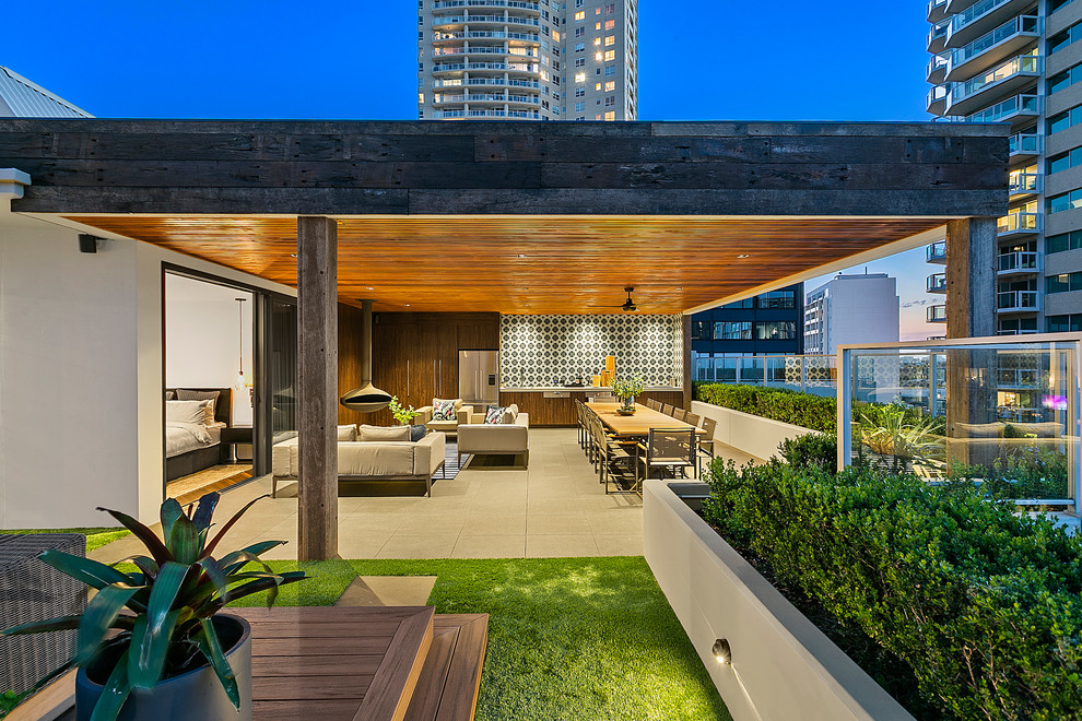 This is an example of a large modern balcony in Sydney with a pergola.