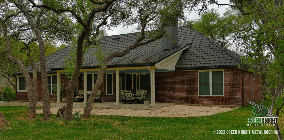 This is an example of a medium sized traditional bungalow detached house in Austin with a metal roof and a grey roof.