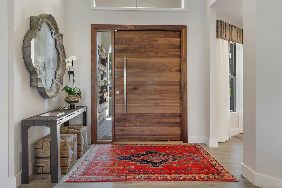 Inspiration for a scandinavian entryway in Miami with a pivot front door and a medium wood front door.