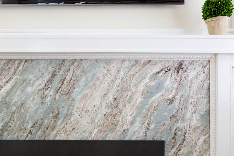 Minimalist living room photo in Boston with a standard fireplace and a stone fireplace