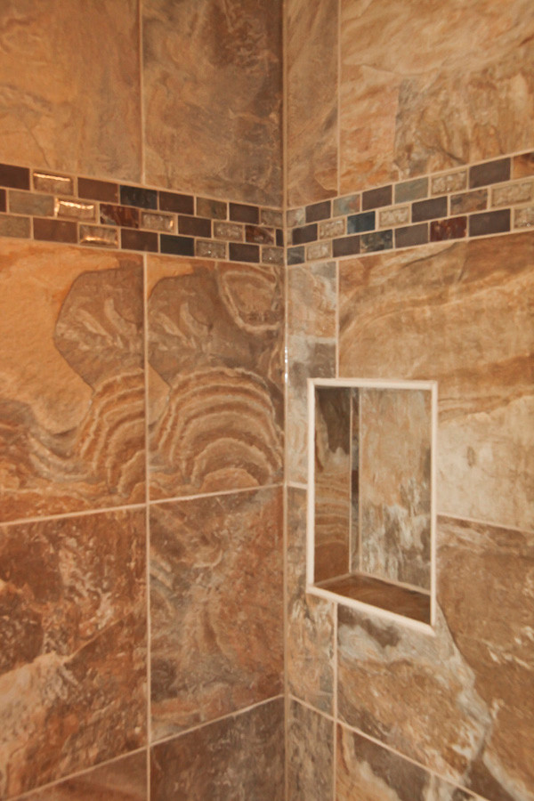 Drop-in bathtub - rustic beige tile and terra-cotta tile ceramic tile drop-in bathtub idea in Milwaukee with a console sink, shaker cabinets, medium tone wood cabinets, granite countertops, a two-piece toilet and beige walls