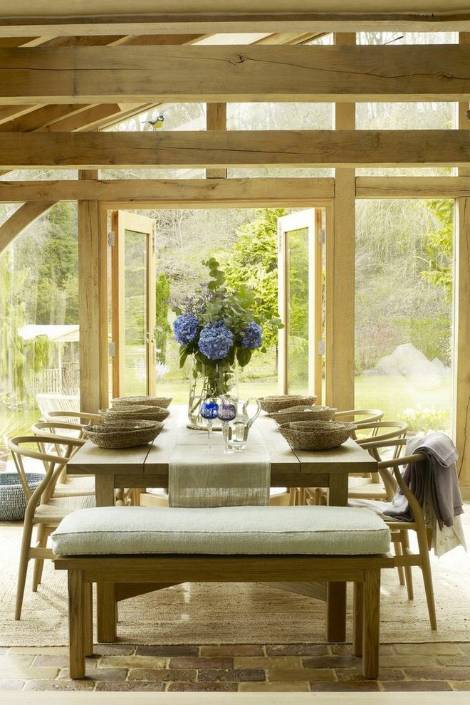 This is an example of a country dining room in London with no fireplace.