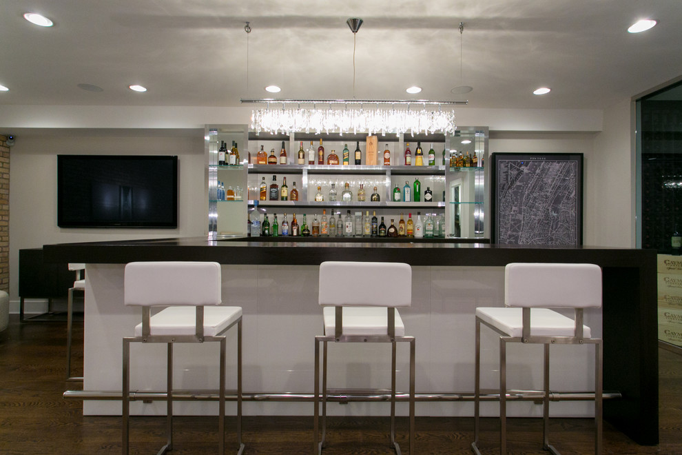 Design ideas for a large contemporary u-shaped seated home bar in New York with glass benchtops, white splashback, dark hardwood floors and open cabinets.