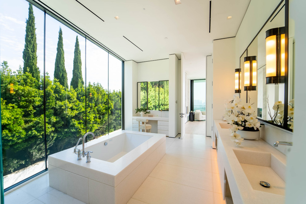 Example of a minimalist master beige floor and double-sink bathroom design in San Francisco with beige cabinets, an undermount tub, white walls, an integrated sink, beige countertops and a built-in vanity