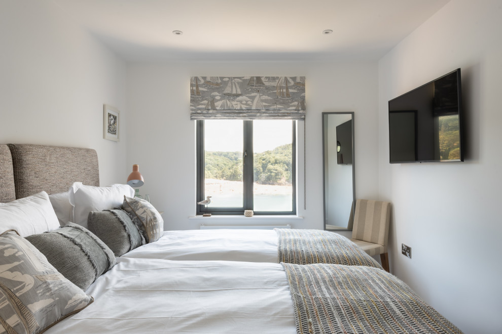 Medium sized contemporary master bedroom in Devon with white walls and beige floors.