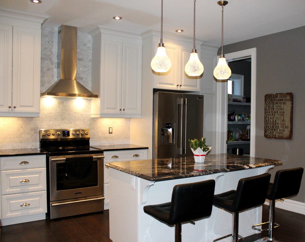 Example of a mid-sized transitional l-shaped dark wood floor open concept kitchen design in Toronto with an undermount sink, raised-panel cabinets, white cabinets, quartzite countertops, gray backsplash, subway tile backsplash, stainless steel appliances and an island