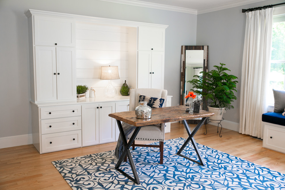 Example of a transitional master light wood floor bedroom design in Portland Maine with gray walls