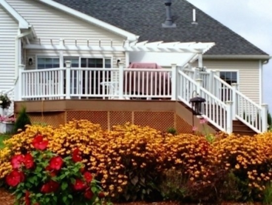 Example of a backyard deck design in Boston with an awning
