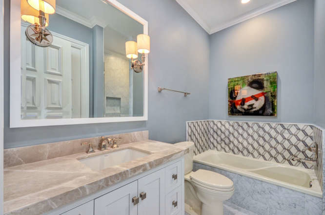 Inspiration for a mid-sized transitional bathroom in Tampa with glass-front cabinets, dark wood cabinets, a drop-in tub, a two-piece toilet, gray tile, marble, grey walls, marble floors, an undermount sink, marble benchtops, grey floor and a hinged shower door.
