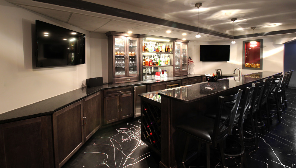 Design ideas for a mid-sized transitional u-shaped seated home bar in Chicago with an undermount sink, glass-front cabinets, dark wood cabinets, granite benchtops, linoleum floors, black floor and black benchtop.