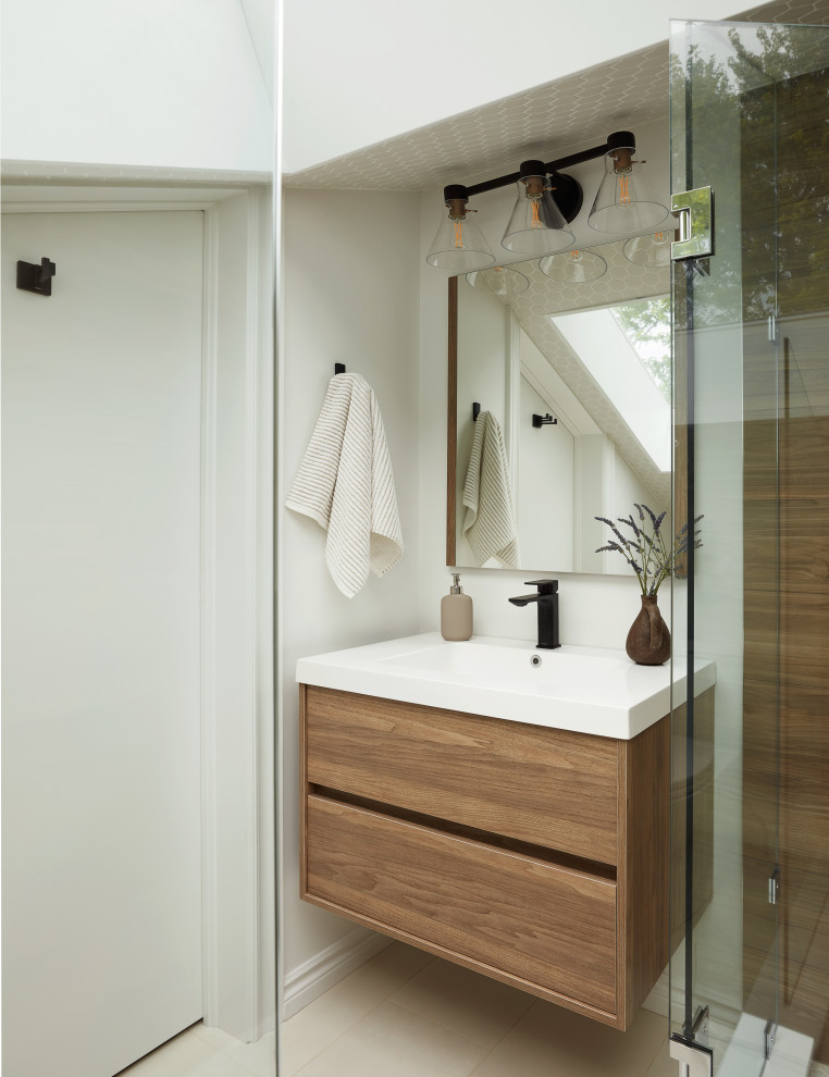 Small master wet room bathroom in Toronto with flat-panel cabinets, medium wood cabinets, a one-piece toilet, brown tile, ceramic tile, an integrated sink, a hinged shower door, a single vanity and a floating vanity.