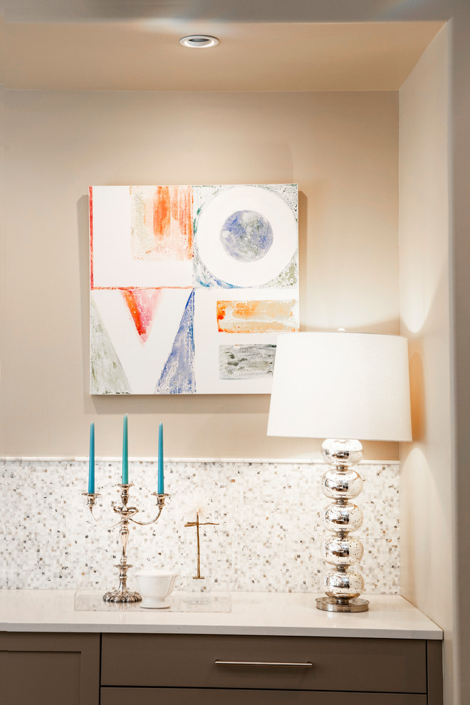 Example of a mid-sized transitional ceramic tile and brown floor enclosed kitchen design with an undermount sink, flat-panel cabinets, beige cabinets, quartzite countertops, white backsplash, ceramic backsplash, stainless steel appliances, two islands and white countertops