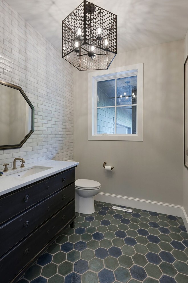 Photo of a mid-sized contemporary 3/4 bathroom in Minneapolis with furniture-like cabinets, dark wood cabinets, gray tile, grey walls, an undermount sink, green floor, subway tile, porcelain floors and engineered quartz benchtops.