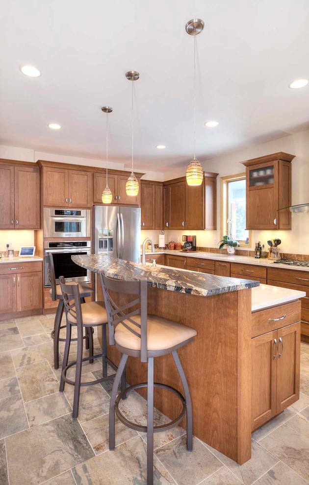 Inspiration for a mid-sized transitional u-shaped slate floor eat-in kitchen remodel with an undermount sink, flat-panel cabinets, medium tone wood cabinets, granite countertops, brown backsplash, stone tile backsplash, stainless steel appliances and an island
