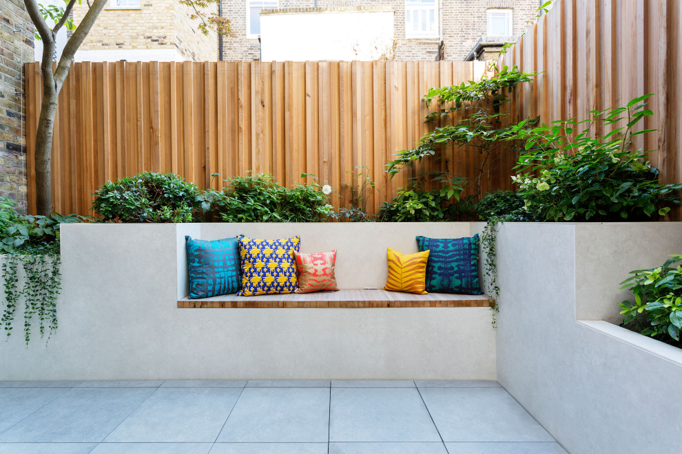 Inspiration for a contemporary patio in London with fencing.
