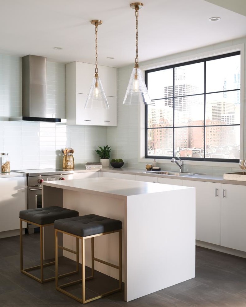 Inspiration for a small transitional l-shaped medium tone wood floor and brown floor eat-in kitchen remodel with a drop-in sink, flat-panel cabinets, white cabinets, laminate countertops, white backsplash, ceramic backsplash, stainless steel appliances and an island