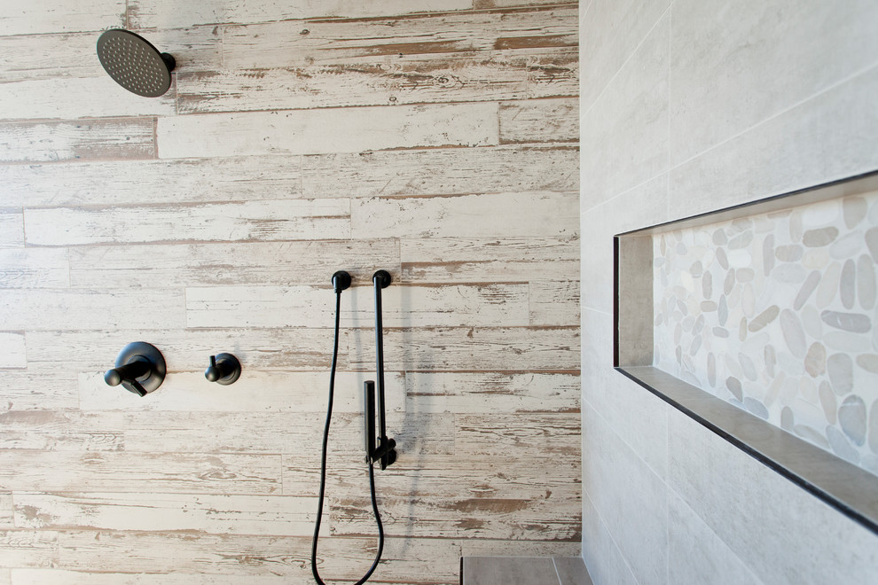 Photo of a large contemporary master bathroom in Calgary with brown tile, an open shower, an alcove shower, pebble tile, pebble tile floors and beige floor.