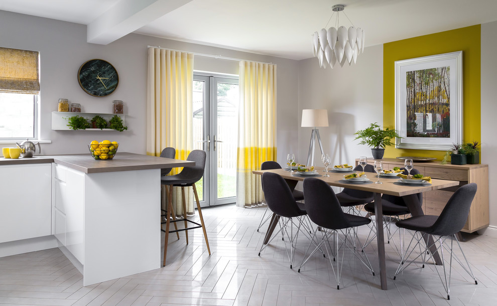 Photo of a contemporary kitchen/dining combo in Dublin with porcelain floors, yellow walls and white floor.