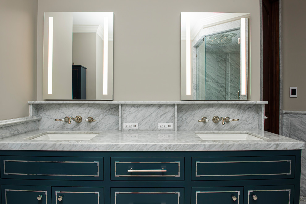 Esempio di una stanza da bagno padronale eclettica di medie dimensioni con ante lisce, ante blu, piastrelle grigie, piastrelle di marmo, pareti beige, lavabo sottopiano, due lavabi, mobile bagno incassato e top in marmo