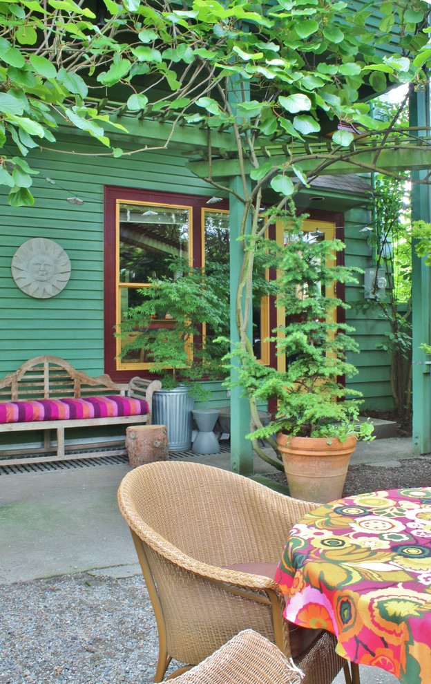 Eclectic backyard verandah with a vegetable garden and concrete slab.