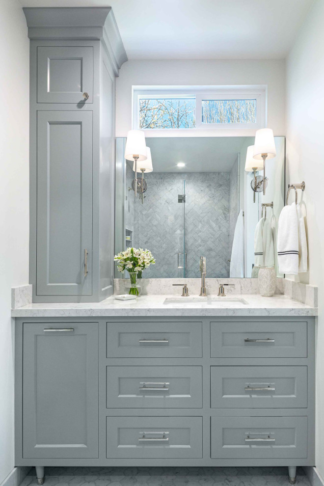 Mid-sized elegant master gray tile and marble tile marble floor, gray floor and single-sink bathroom photo in San Francisco with shaker cabinets, white walls, an undermount sink, quartz countertops, a hinged shower door, white countertops, a built-in vanity and gray cabinets
