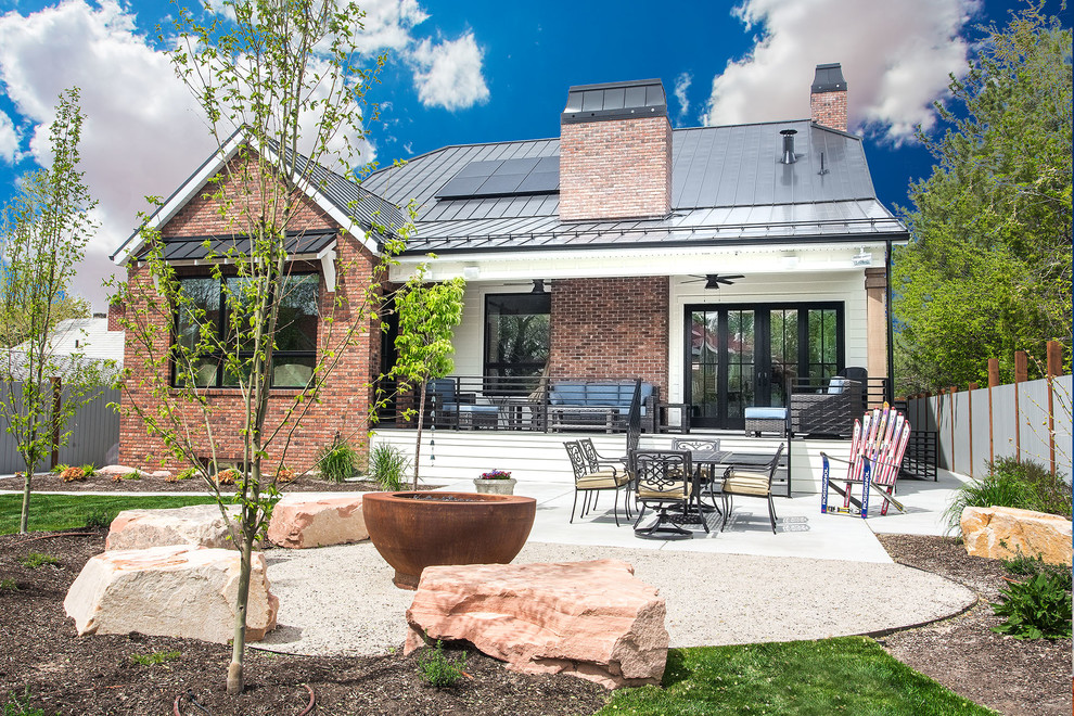 Design ideas for a mid-sized country backyard full sun garden in Salt Lake City with a fire feature and concrete pavers.