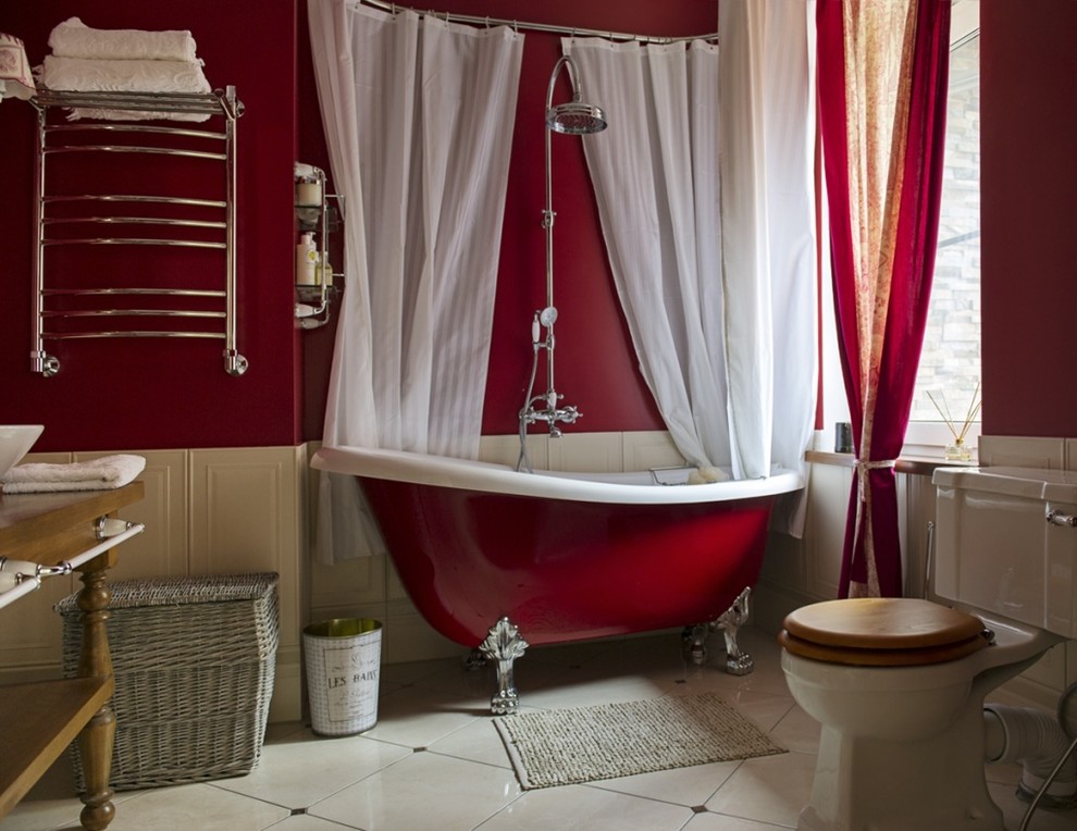 Photo of a contemporary bathroom in Moscow with a claw-foot tub, a shower/bathtub combo, a one-piece toilet, stone tile, red walls, porcelain floors and a vessel sink.