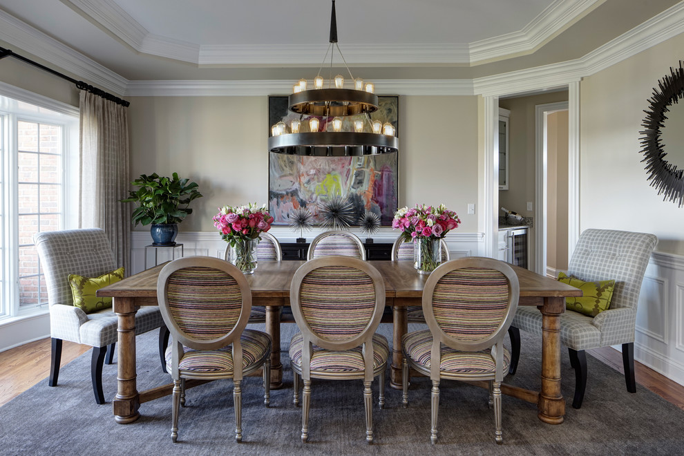 Design ideas for a transitional separate dining room in Chicago with beige walls and medium hardwood floors.