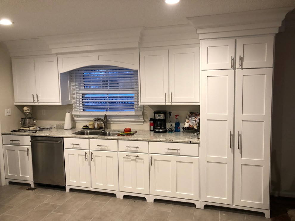 Eat-in kitchen - mid-sized transitional u-shaped porcelain tile and gray floor eat-in kitchen idea with shaker cabinets, white cabinets, granite countertops, stainless steel appliances, no island, a double-bowl sink and white countertops