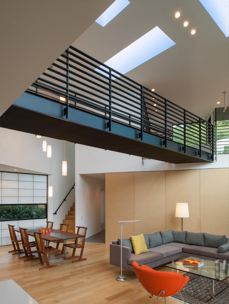 Inspiration for a contemporary light wood floor living room remodel in DC Metro with white walls