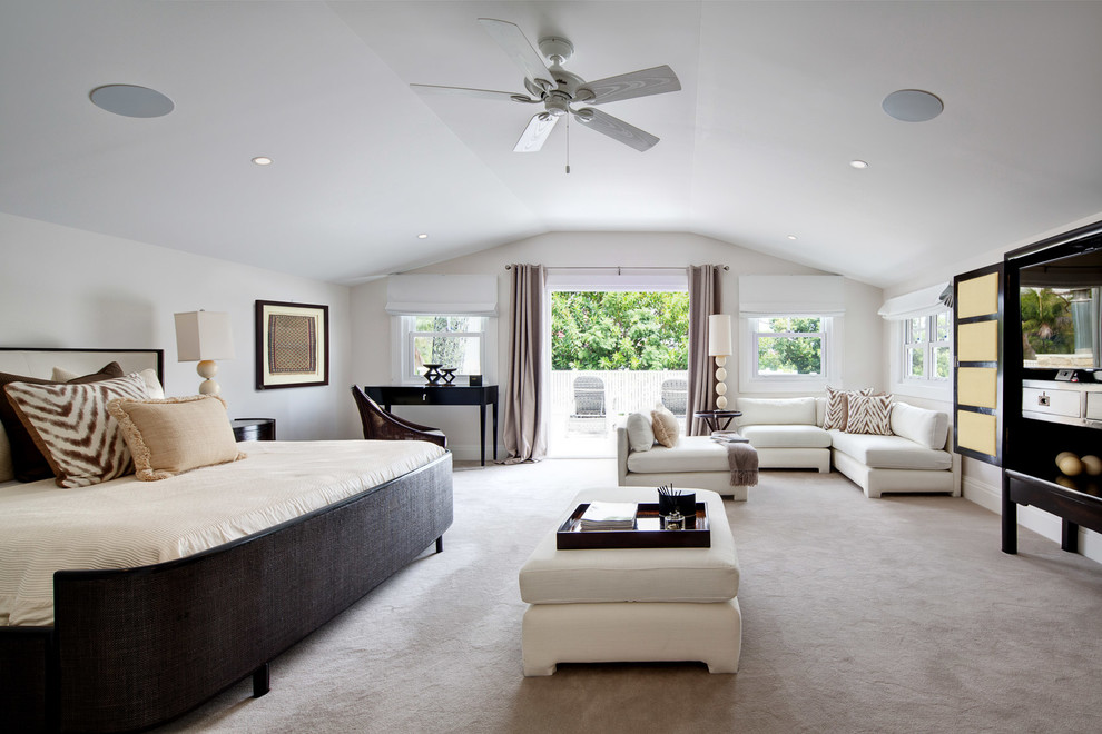 This is an example of a large traditional master bedroom in Sydney with white walls and carpet.