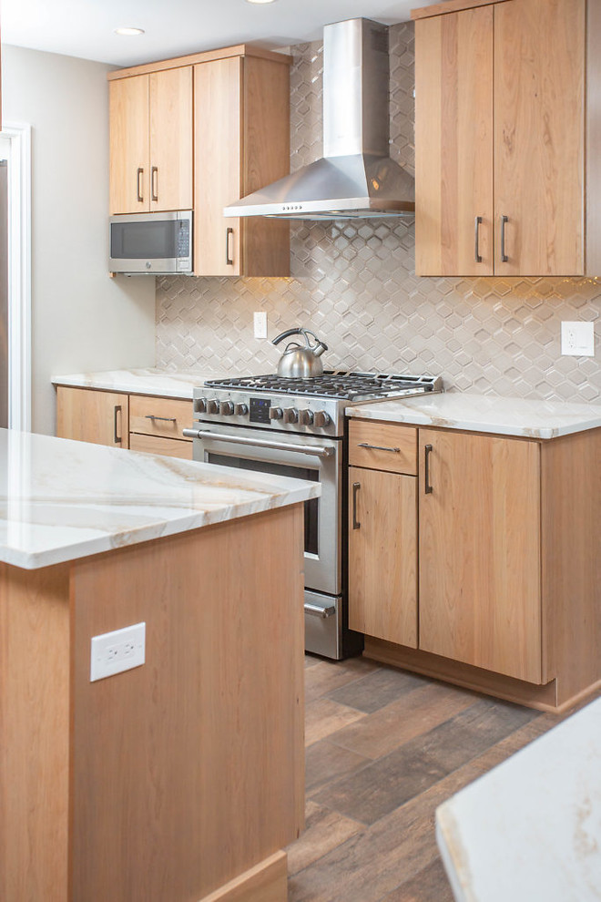 Eat-in kitchen - mid-sized transitional galley eat-in kitchen idea with flat-panel cabinets, medium tone wood cabinets, quartz countertops and stainless steel appliances