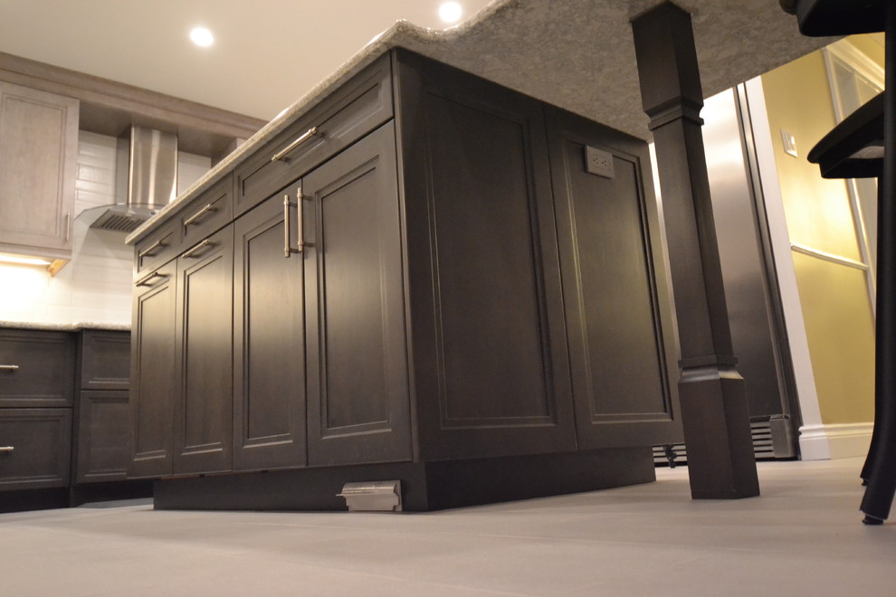 Example of a mid-sized transitional u-shaped eat-in kitchen design in Ottawa with recessed-panel cabinets and an island