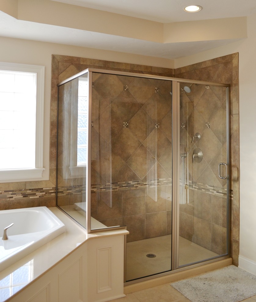 This is an example of a traditional bathroom in Indianapolis with a corner tub, brown tile and matchstick tile.