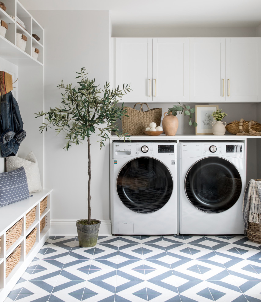 Inspiration for a transitional laundry room in New York with shaker cabinets, white cabinets, white walls, porcelain floors and blue floor.