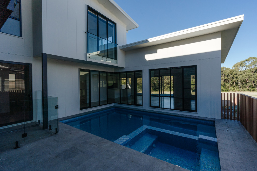 Inspiration for a mid-sized courtyard rectangular pool in Wollongong with tile.