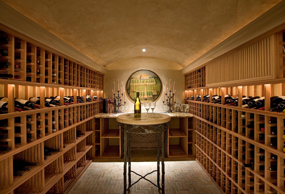 This is an example of a mediterranean wine cellar in Santa Barbara with brick floors and grey floor.