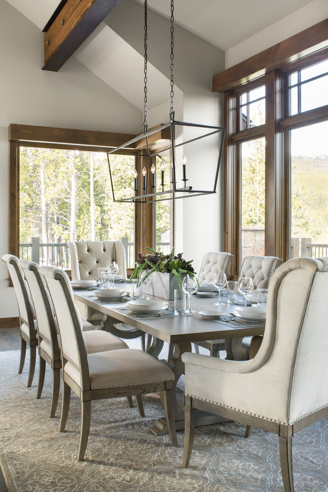 Photo of a transitional dining room in Denver with white walls, dark hardwood floors and brown floor.