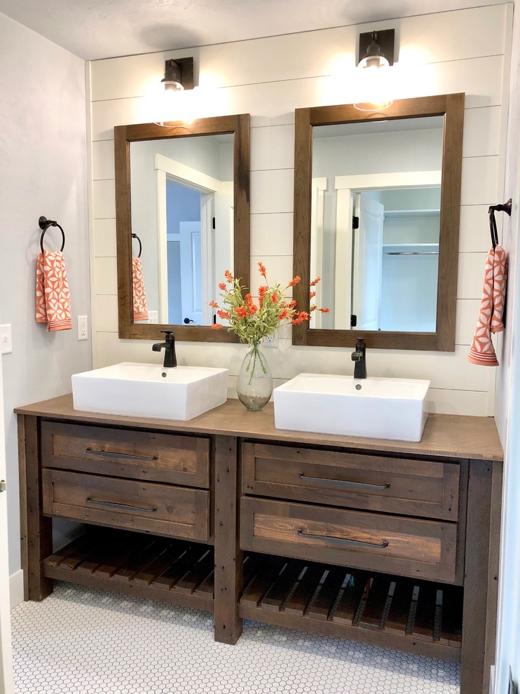 Photo of a mid-sized country master bathroom in Other with distressed cabinets, grey walls, ceramic floors, a vessel sink, wood benchtops, white floor and brown benchtops.