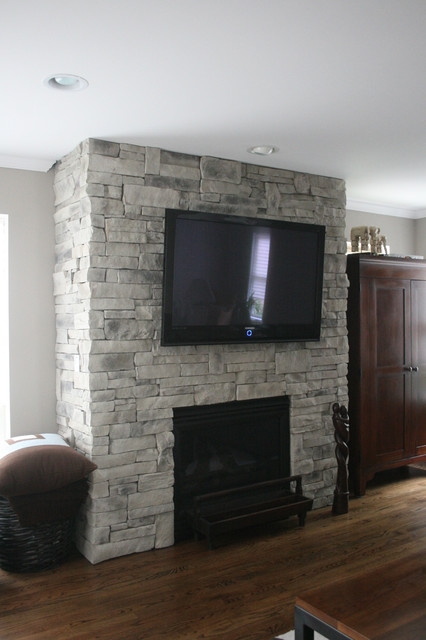 Beautiful white/grey custom colored ledge stone dry stack stone fireplace with flat screen television installed