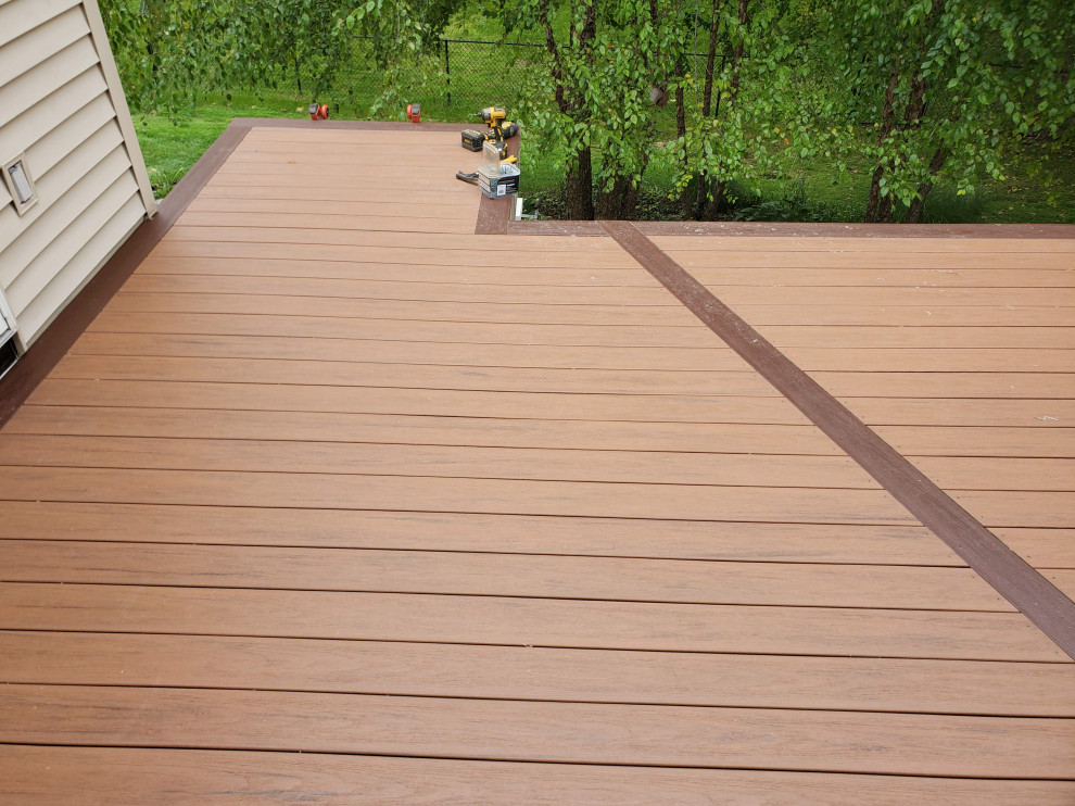 Mid-sized backyard second story metal railing deck photo with no cover