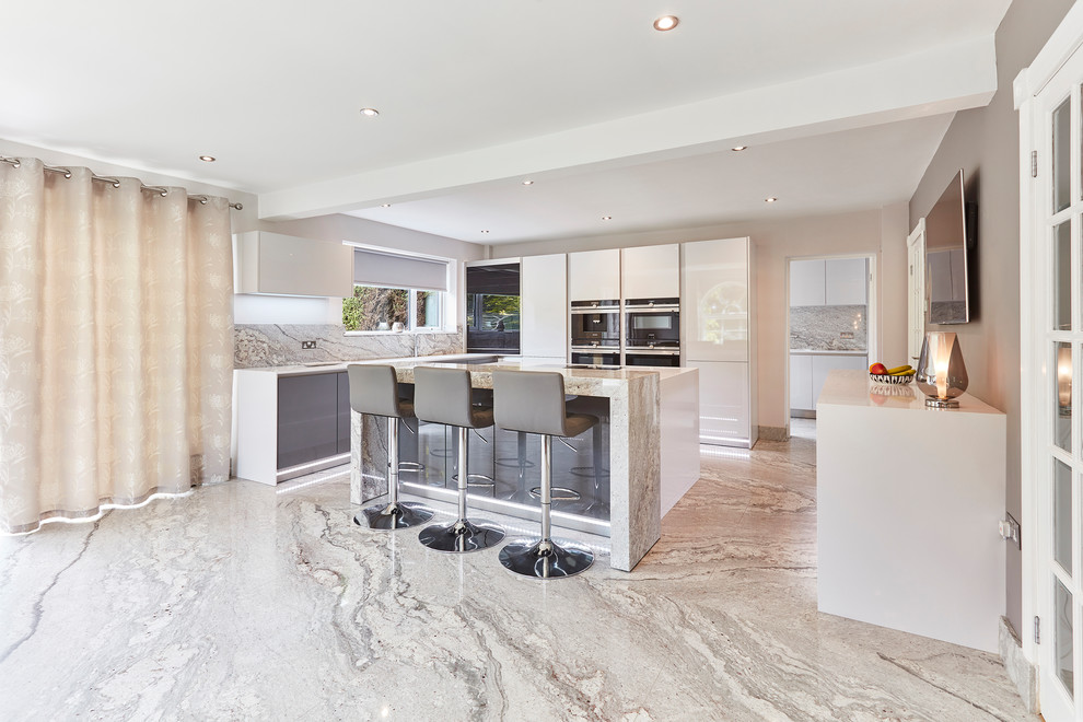 Photo of a mid-sized contemporary u-shaped eat-in kitchen in Other with an integrated sink, flat-panel cabinets, white cabinets, quartzite benchtops, grey splashback, stone slab splashback, black appliances, marble floors, with island, grey floor, white benchtop and coffered.