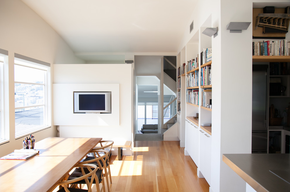 Inspiration for a mid-sized contemporary separate dining room in San Francisco with white walls and light hardwood floors.