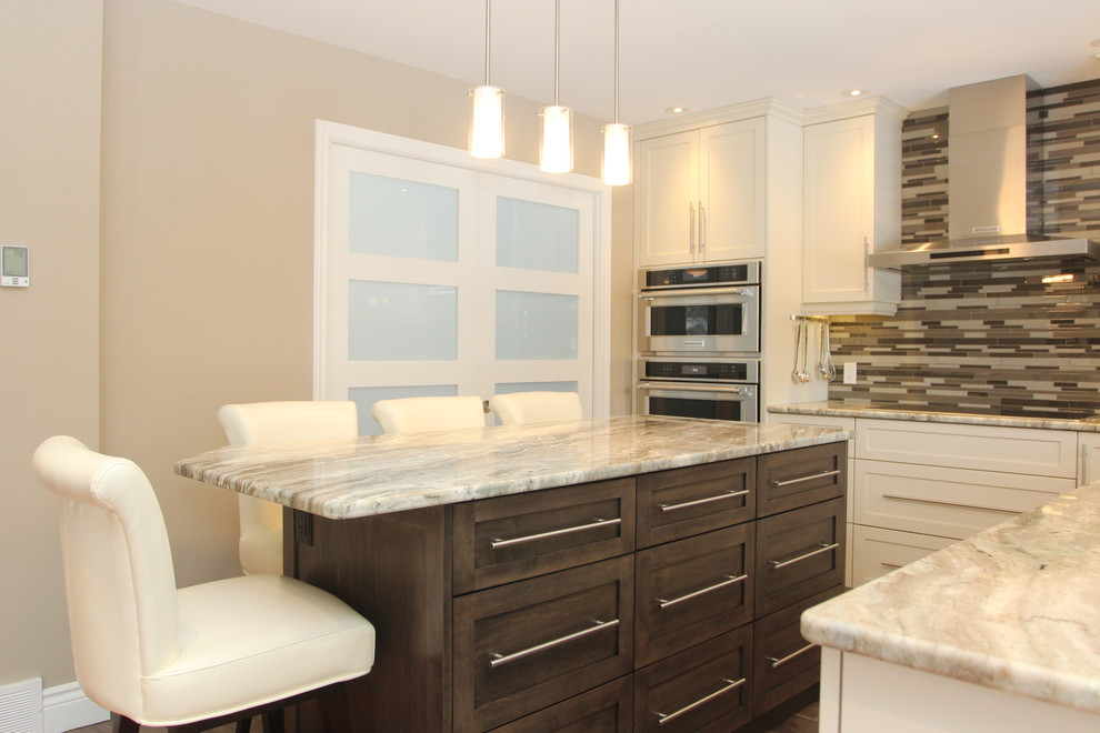 Eat-in kitchen - mid-sized transitional l-shaped eat-in kitchen idea with dark wood cabinets, granite countertops, multicolored backsplash, glass tile backsplash, stainless steel appliances, an island and shaker cabinets