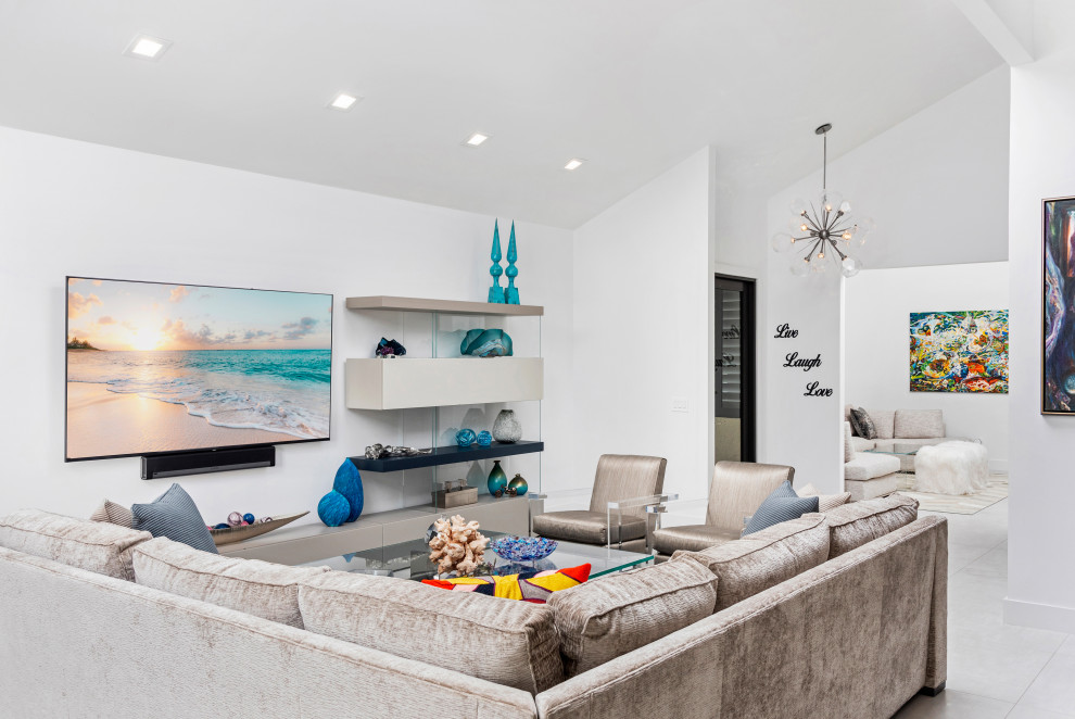 This is an example of a large contemporary open plan living room in Miami with white walls, marble flooring, a wall mounted tv, beige floors and a vaulted ceiling.