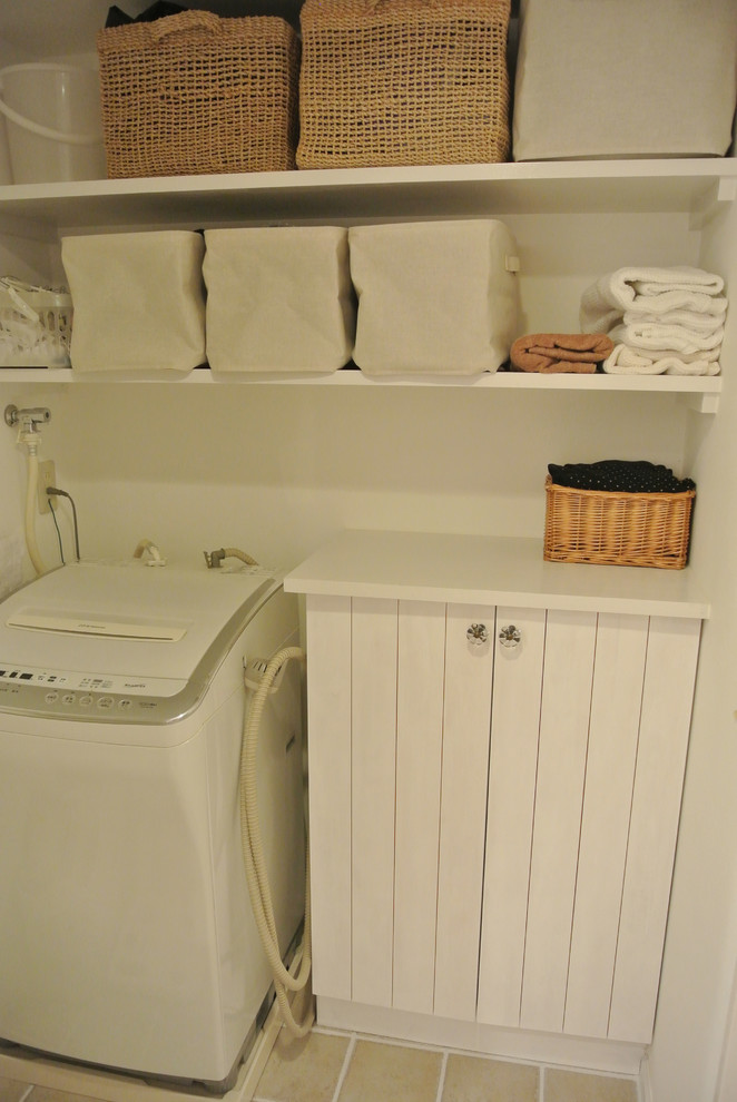 Photo of a small country single-wall dedicated laundry room in Nagoya with flat-panel cabinets, white cabinets, wood benchtops, white walls, ceramic floors and an integrated washer and dryer.