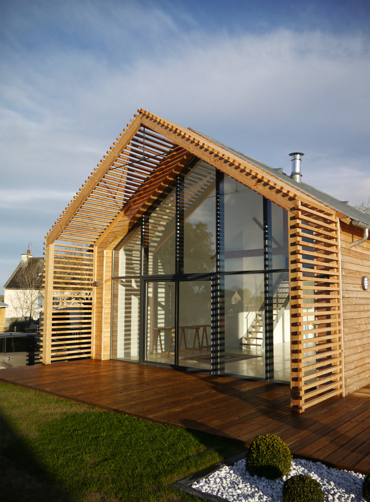 This is an example of a mid-sized contemporary deck in Rennes with an awning.